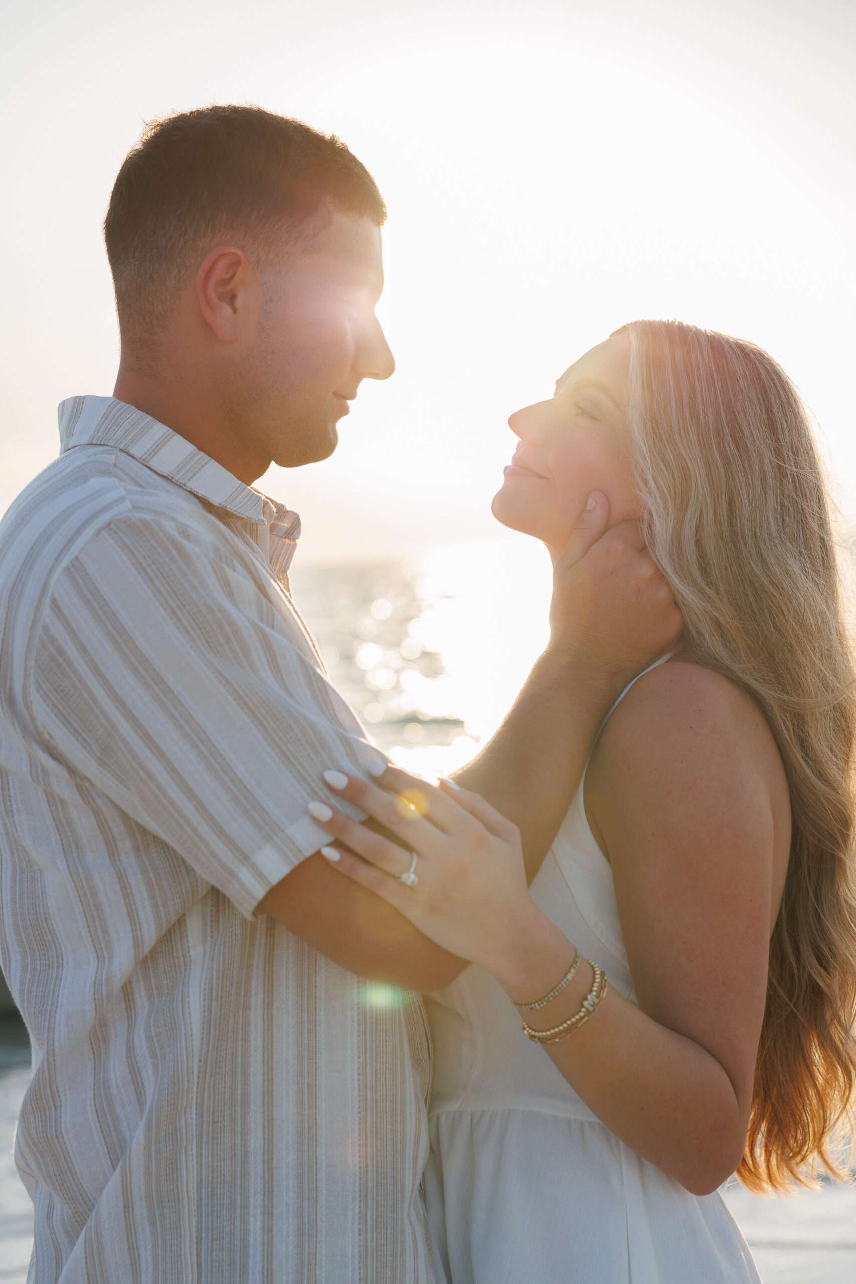 A close-up of two people in an intimate embrace, showcasing their arms and shoulders, with a soft focus background.